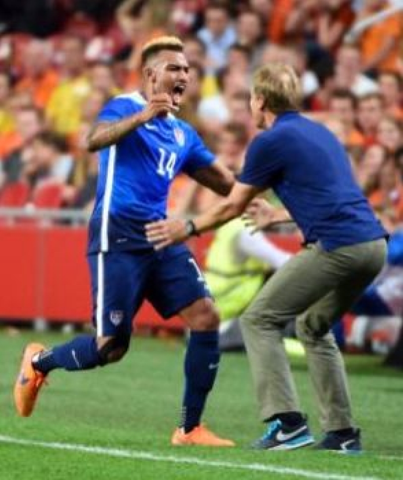 Coach Jurgen Klinsmann with teammate.