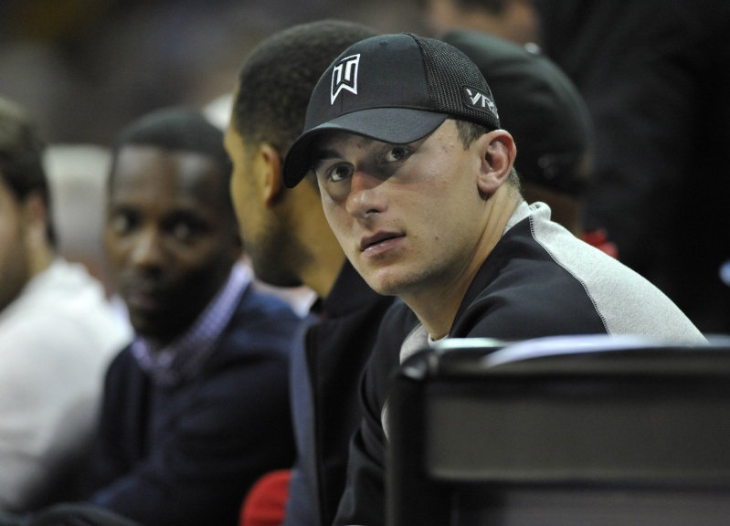 Cleveland Browns quarterback Johnny Manziel watches the game from the front row in the second quarter at Quicken Loans Arena, in Cleveland