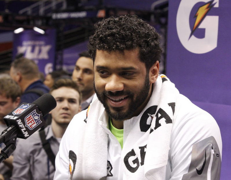 Russell Wilson answers media questions at Super Bowl XLIX media day 