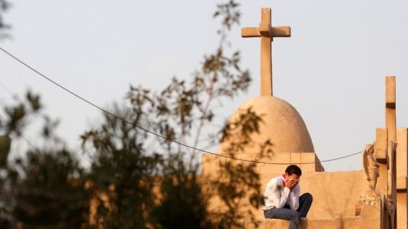 A man cries during the funeral of victims killed in the bombing of Cairo's Coptic cathedral, at the Mokattam Cemetery in Cairo, Egypt.