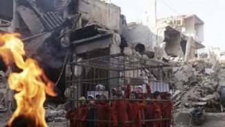 Syrian Children Dressed as ISIS Hostages, Placed in Cage in Protest of President Assad Regime