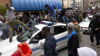 Baltimore Police Suffer 'Major Injuries' during Violent Overnight Protests over Death of Freddie Gray