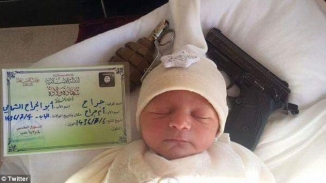 ISIS Releases Propaganda Image of Newborn Sleeping Next to Gun, Hand Grenade: 'This Child Will Be a Risk to You'